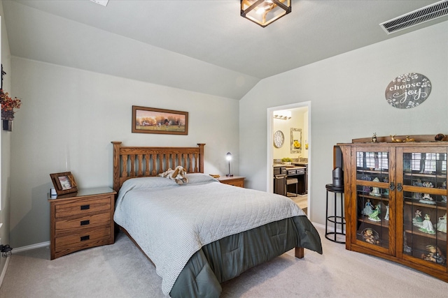 901 Freesia Dr, Little Elm, TX 75068 - bedroom with lofted ceiling, light colored carpet, baseboards, and ensuite bath