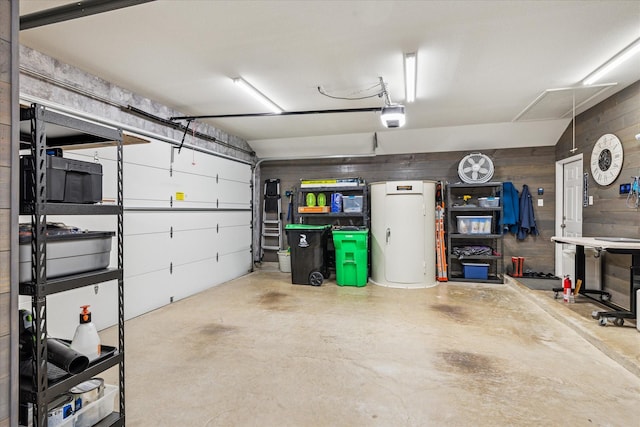 901 Freesia Dr, Little Elm, TX 75068 - garage featuring a garage door opener and wood walls