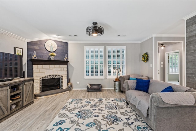 901 Freesia Dr, Little Elm, TX 75068 - living room featuring a fireplace, light wood finished floors, ornamental molding, and baseboards