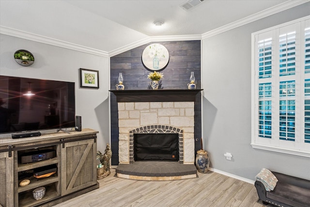 901 Freesia Dr, Little Elm, TX 75068 - living area featuring wood finished floors, vaulted ceiling, crown molding, a fireplace with raised hearth, and wood walls