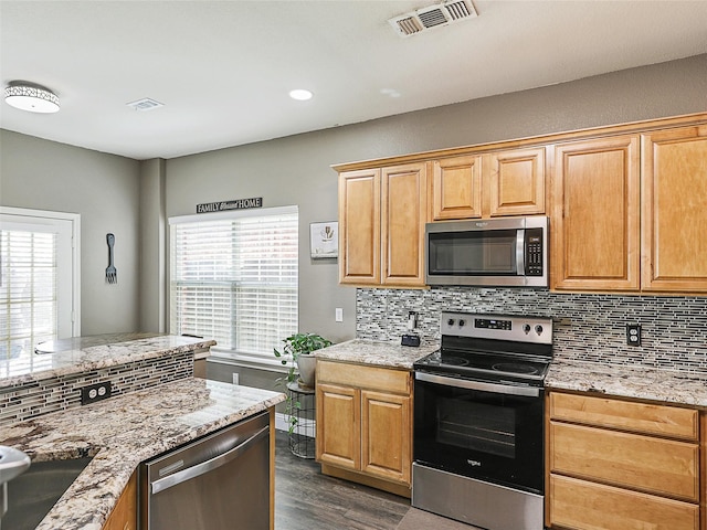 157 Castleridge Dr Unit B, Little Elm, TX 75068 - kitchen featuring appliances with stainless steel finishes, decorative backsplash, dark wood-style floors, light stone counters, and recessed lighting