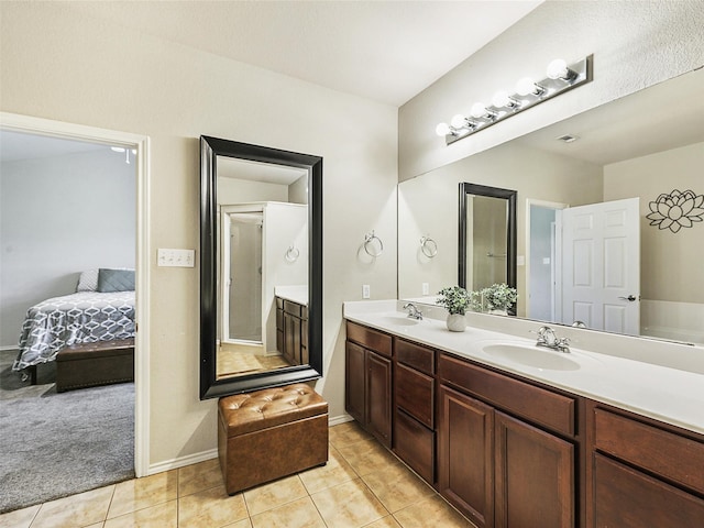 157 Castleridge Dr Unit B, Little Elm, TX 75068 - ensuite bathroom featuring double vanity, tile patterned floors, and baseboards