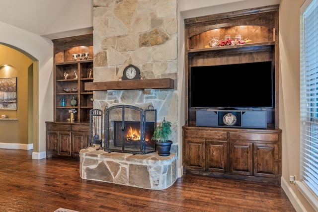 436 Highbluff Trl, Royse City, TX 75189 - living area with dark wood-style floors, arched walkways, a fireplace, and built in features