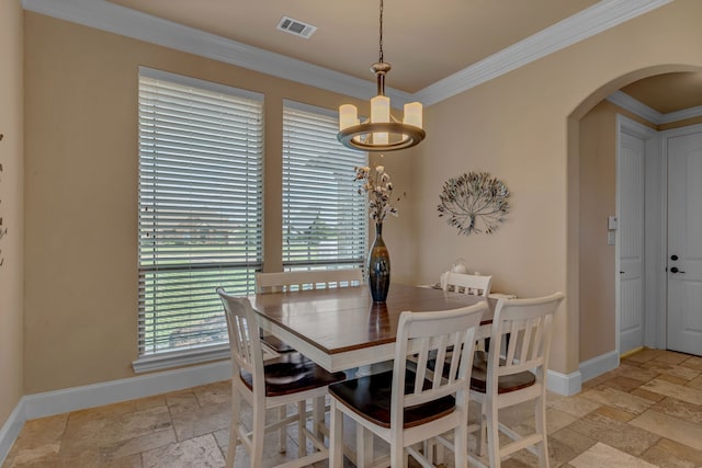 436 Highbluff Trl, Royse City, TX 75189 - dining area with stone tile flooring, arched walkways, a chandelier, and crown molding