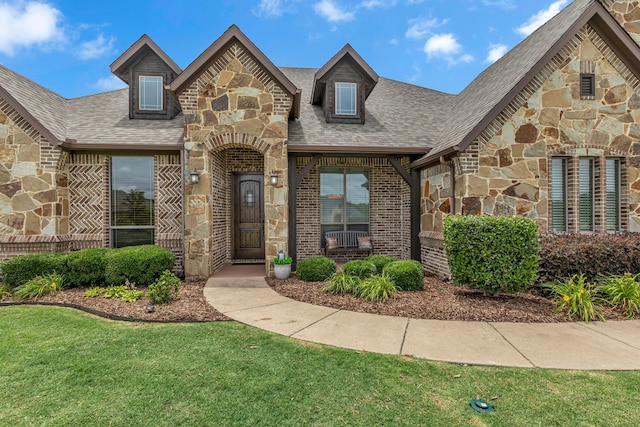 436 Highbluff Trl, Royse City, TX 75189 - view of front of home with stone siding, a front yard, roof with shingles, and brick siding