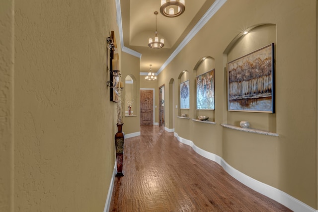 436 Highbluff Trl, Royse City, TX 75189 - hallway with ornamental molding, a chandelier, wood finished floors, and arched walkways