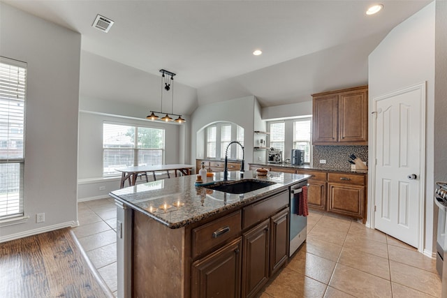 1012 Honeywell Dr, Anna, TX 75409 - kitchen with a sink, lofted ceiling, stainless steel appliances, healthy amount of natural light, and dark stone counters