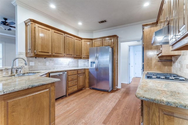 805 Evergreen Ct, Keller, TX 76248 - kitchen featuring stainless steel appliances, a sink, under cabinet range hood, light stone countertops, and ornamental molding