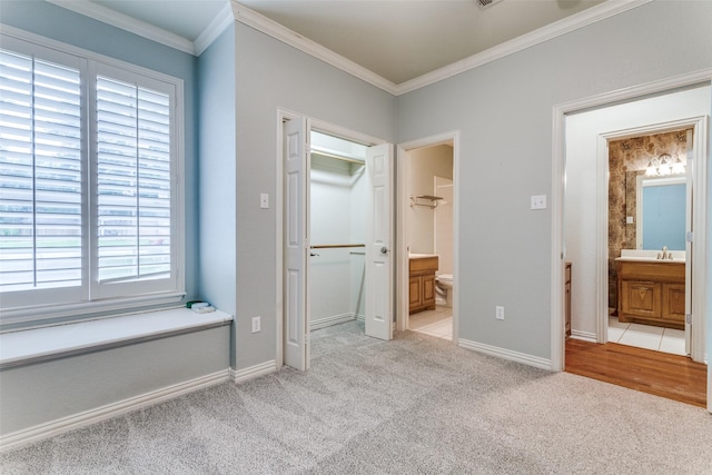 805 Evergreen Ct, Keller, TX 76248 - unfurnished bedroom with light colored carpet, ornamental molding, connected bathroom, baseboards, and a walk in closet