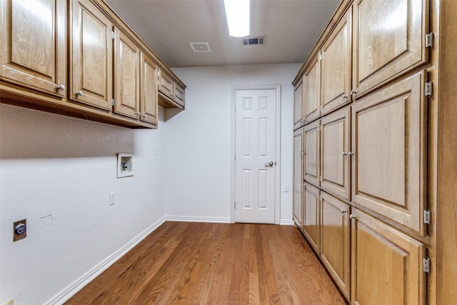 805 Evergreen Ct, Keller, TX 76248 - laundry area with cabinet space, wood finished floors, baseboards, washer hookup, and hookup for an electric dryer