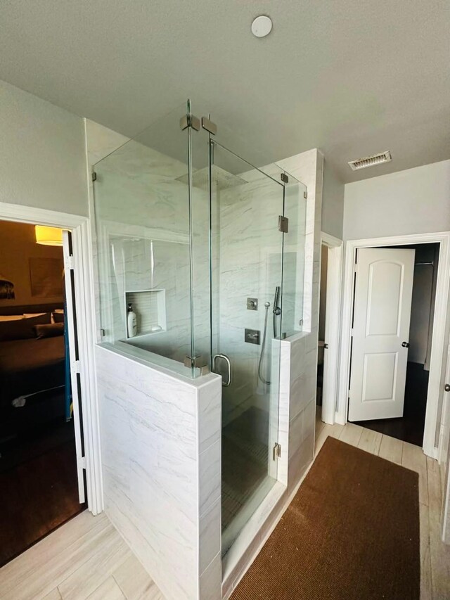 5701 Pantheon Ct, Plano, TX 75024 - bathroom with a stall shower and wood finished floors