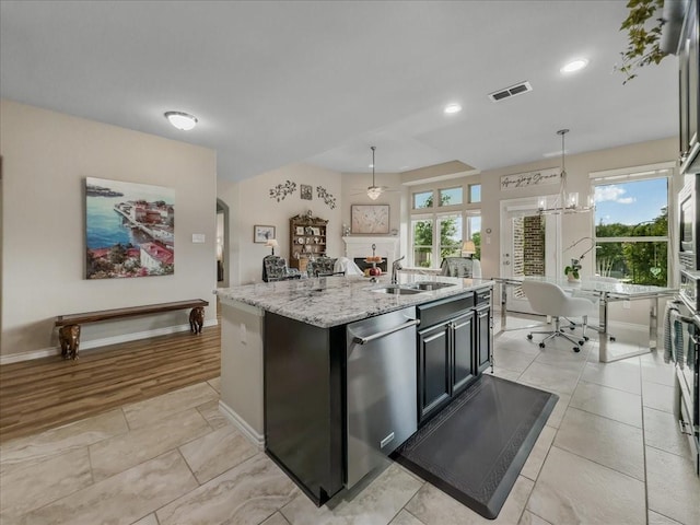 1316 Heather Ln, Little Elm, TX 75068 - kitchen featuring stainless steel dishwasher, plenty of natural light, hanging light fixtures, light stone counters, and recessed lighting