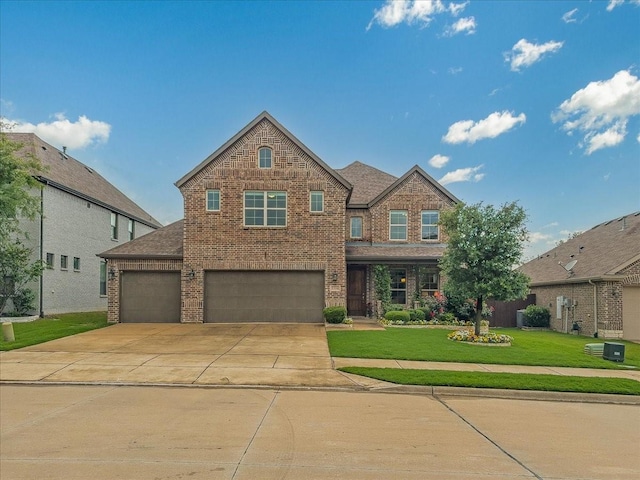 1316 Heather Ln, Little Elm, TX 75068 - view of front of property with brick siding, a front lawn, driveway, and a garage