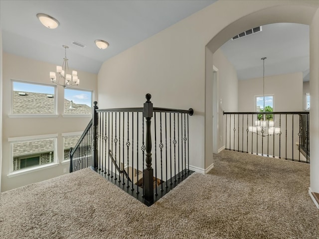 1316 Heather Ln, Little Elm, TX 75068 - stairway featuring a chandelier, carpet flooring, arched walkways, and lofted ceiling