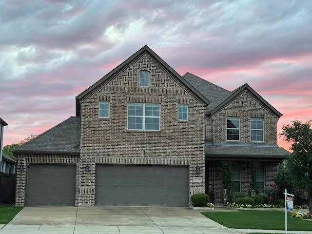 1316 Heather Ln, Little Elm, TX 75068 - view of front of house with driveway, brick siding, roof with shingles, and an attached garage