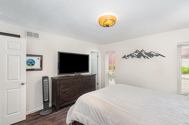 4317 Hartford St Unit 102, Dallas, TX 75219 - bedroom featuring dark wood finished floors, baseboards, and multiple windows