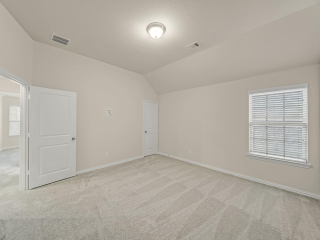 413 Winehart St, Lewisville, TX 75056 - spare room with light colored carpet, lofted ceiling, and baseboards