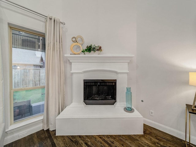 413 Winehart St, Lewisville, TX 75056 - detailed view of wood finished floors, baseboards, and a fireplace with raised hearth