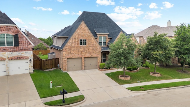 1003 Fenwick Ln, Forney, TX 75126 - tudor home with driveway, brick siding, an attached garage, a shingled roof, and stone siding