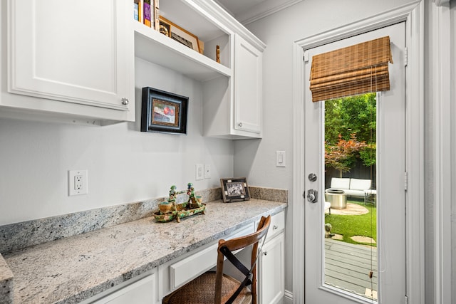 5507 W Amherst Ave, Dallas, TX 75209 - kitchen with white cabinetry, open shelves, light stone countertops, and crown molding