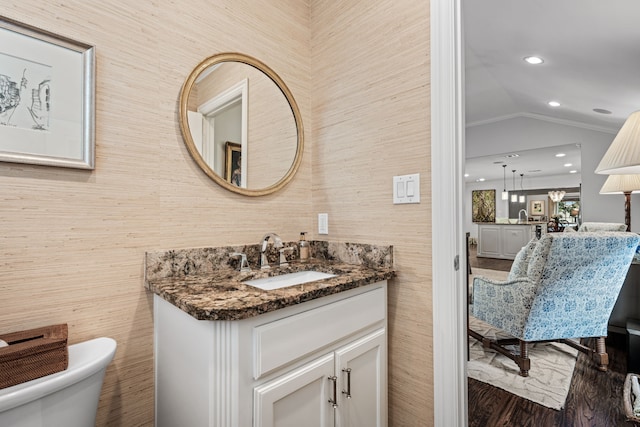 5507 W Amherst Ave, Dallas, TX 75209 - bathroom featuring vanity, toilet, lofted ceiling, wood finished floors, and recessed lighting