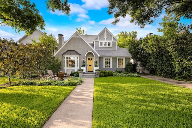 5507 W Amherst Ave, Dallas, TX 75209 - view of front facade featuring a front yard, brick siding, a chimney, and roof with shingles