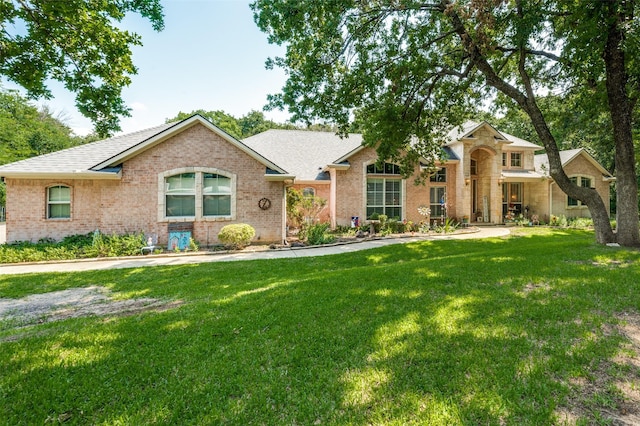 4401 Oak Shores Cir, Cross Roads, TX 76227 - view of front of house with brick siding, a front yard, and roof with shingles