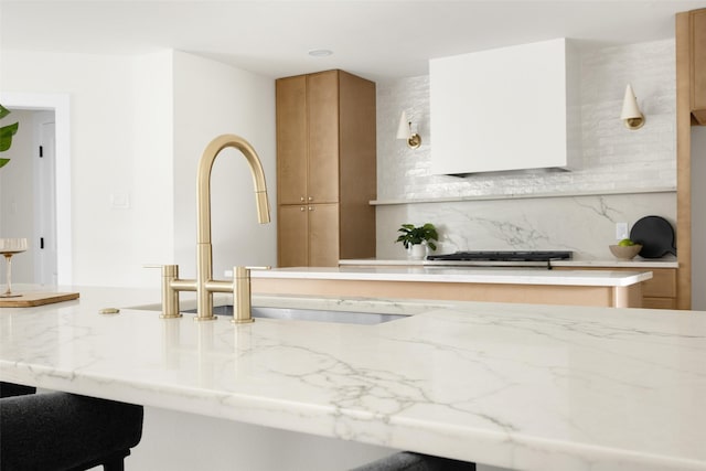 7716 Roundrock Rd, Dallas, TX 75248 - kitchen featuring backsplash, light stone countertops, and brown cabinetry