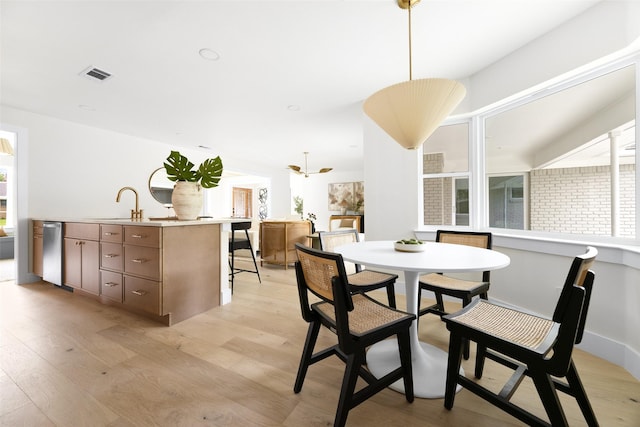 7716 Roundrock Rd, Dallas, TX 75248 - dining area with light wood-style flooring