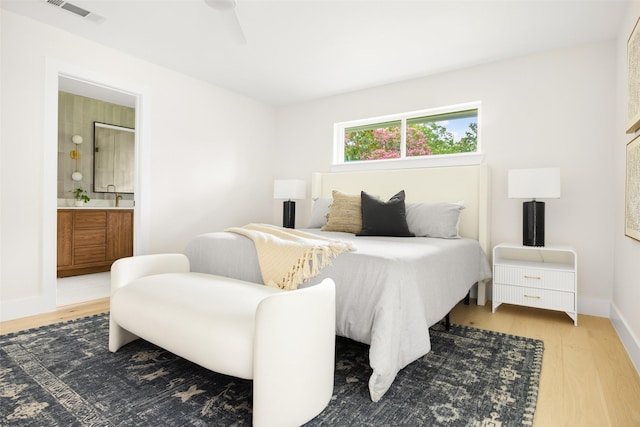 7716 Roundrock Rd, Dallas, TX 75248 - bedroom with wood finished floors and ensuite bath