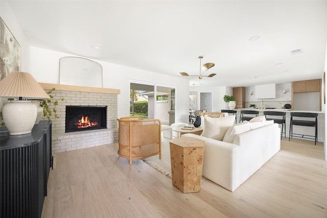 7716 Roundrock Rd, Dallas, TX 75248 - living room with light wood finished floors and a brick fireplace
