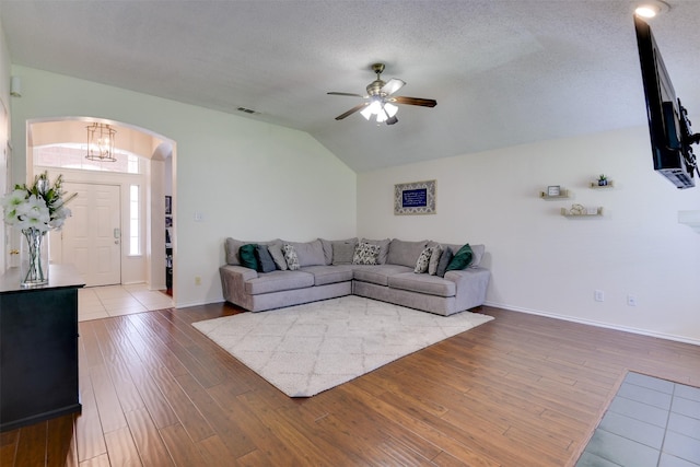 4546 Brittany Ln, Grand Prairie, TX 75052 - living area featuring arched walkways, lofted ceiling, wood-type flooring, a ceiling fan, and baseboards