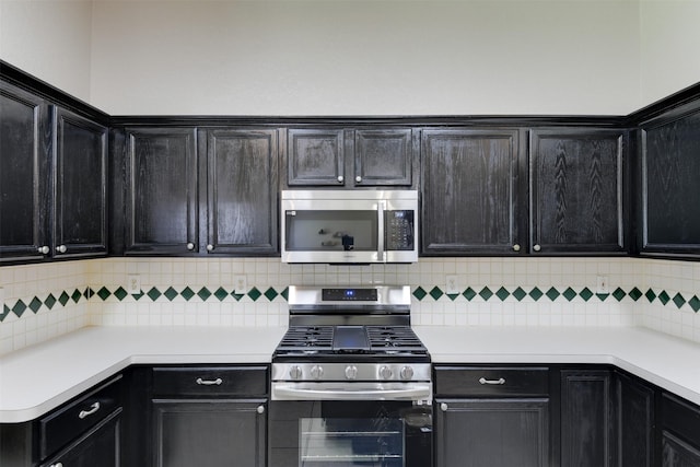 4546 Brittany Ln, Grand Prairie, TX 75052 - kitchen with stainless steel appliances, light countertops, dark cabinets, and decorative backsplash