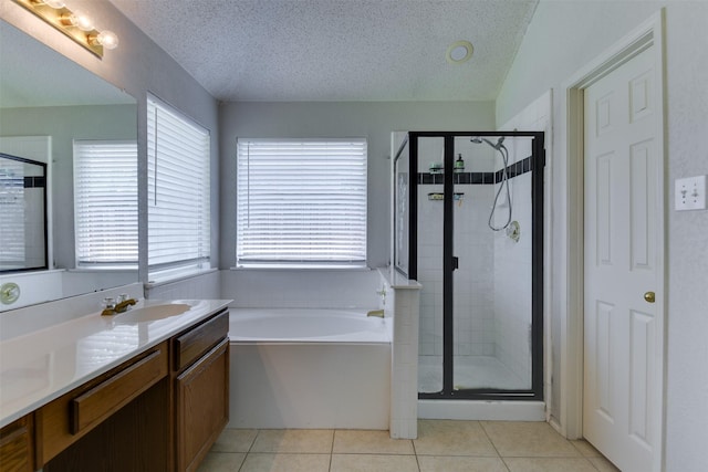 4546 Brittany Ln, Grand Prairie, TX 75052 - full bath featuring a textured ceiling, a garden tub, a shower stall, vanity, and tile patterned floors