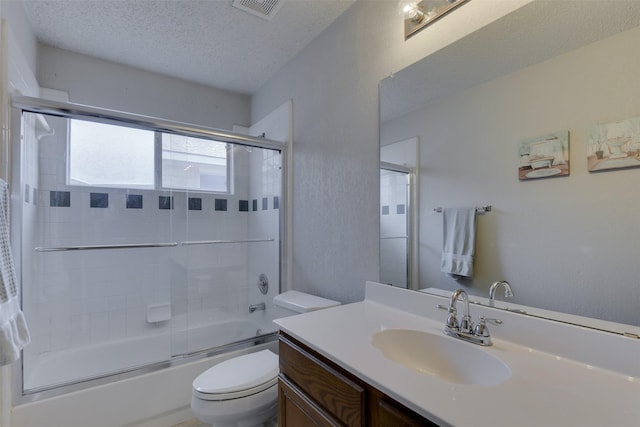 4546 Brittany Ln, Grand Prairie, TX 75052 - bathroom with toilet, vanity, shower / bath combination with glass door, and a textured ceiling
