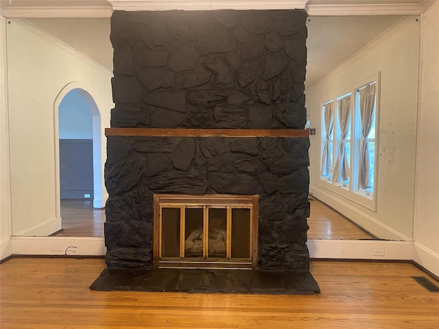 108 Atkins Ave, Shreveport, LA 71104 - detailed view of a large fireplace, wood finished floors, ornamental molding, and arched walkways