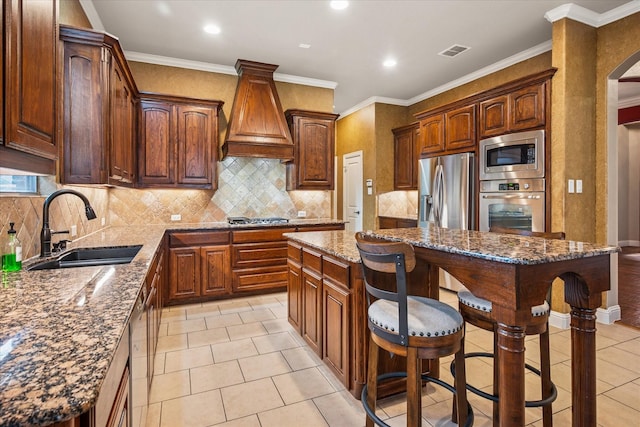 2720 Chapel Springs Dr, Highland Village, TX 75077 - kitchen with stainless steel appliances, a sink, custom range hood, a center island, and a kitchen bar