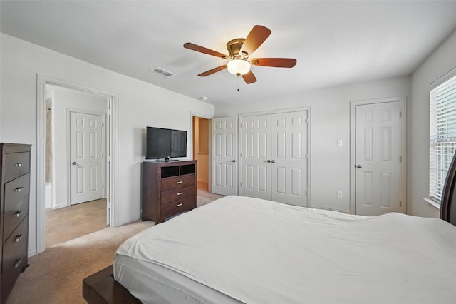 2932 Peyton Brook Dr, Fort Worth, TX 76137 - bedroom with light colored carpet, two closets, ceiling fan, and baseboards