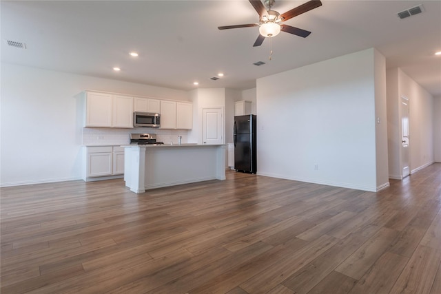 3616 Mallard Way, Mckinney, TX 75071 - kitchen featuring stainless steel microwave, freestanding refrigerator, open floor plan, white cabinets, and a ceiling fan
