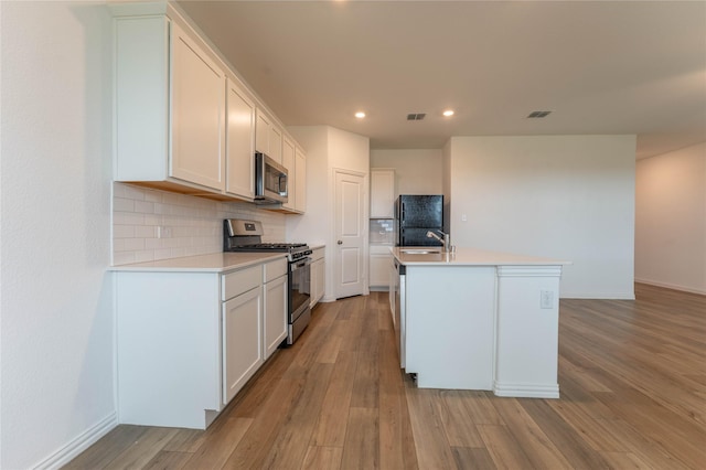 3616 Mallard Way, Mckinney, TX 75071 - kitchen featuring stainless steel appliances, decorative backsplash, light wood-style floors, recessed lighting, and white cabinetry
