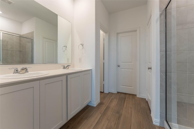 3616 Mallard Way, Mckinney, TX 75071 - full bathroom with a shower stall, wood finished floors, and double vanity