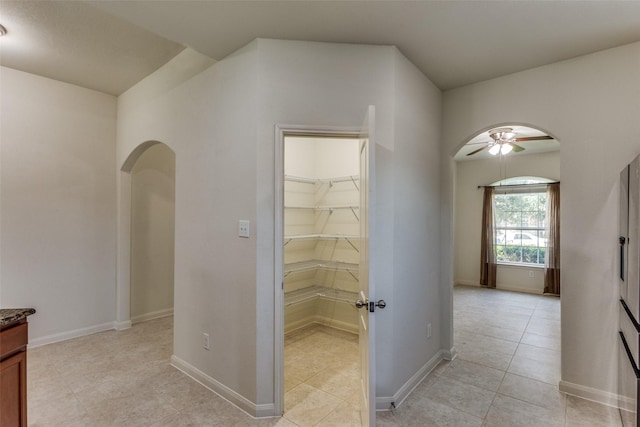 4201 Tower Ln, Crowley, TX 76036 - corridor featuring arched walkways, light tile patterned flooring, and baseboards