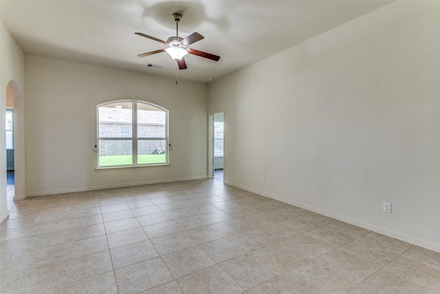 4201 Tower Ln, Crowley, TX 76036 - spare room with arched walkways, a ceiling fan, light tile patterned floors, and baseboards