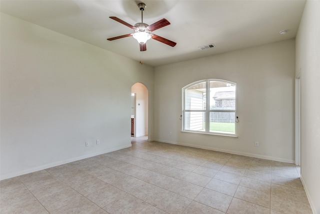 4201 Tower Ln, Crowley, TX 76036 - spare room featuring ceiling fan, arched walkways, light tile patterned floors, and baseboards