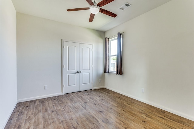 4201 Tower Ln, Crowley, TX 76036 - unfurnished bedroom with wood finished floors, baseboards, a closet, and a ceiling fan