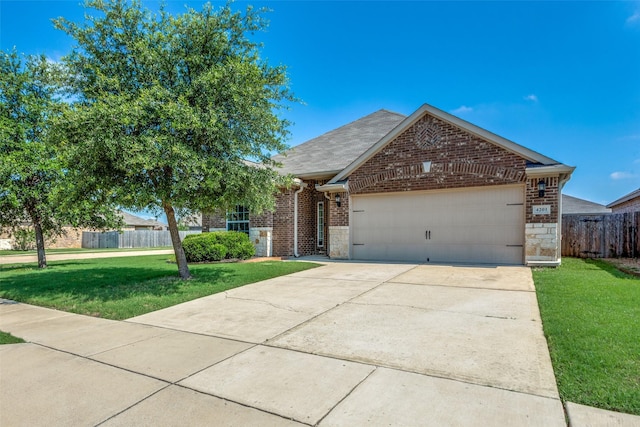 4201 Tower Ln, Crowley, TX 76036 - view of front of home featuring an attached garage, brick siding, driveway, and stone siding