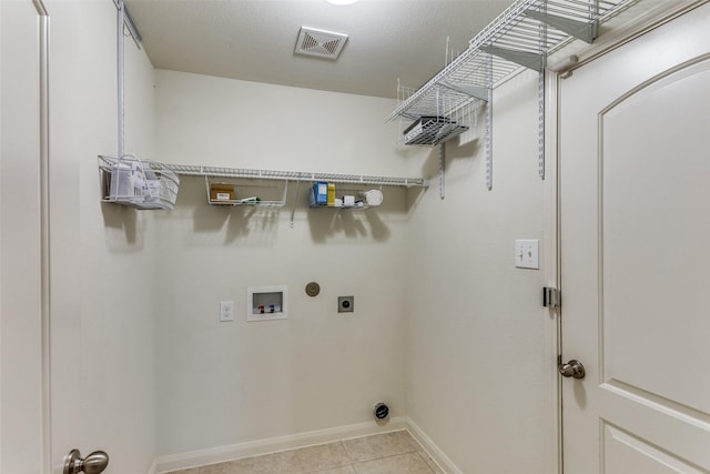 4201 Tower Ln, Crowley, TX 76036 - laundry room with hookup for an electric dryer, baseboards, washer hookup, and light tile patterned floors