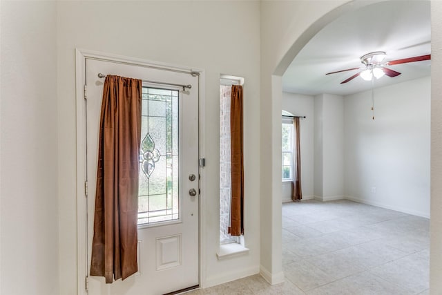 4201 Tower Ln, Crowley, TX 76036 - foyer entrance featuring arched walkways, a ceiling fan, light tile patterned floors, and baseboards