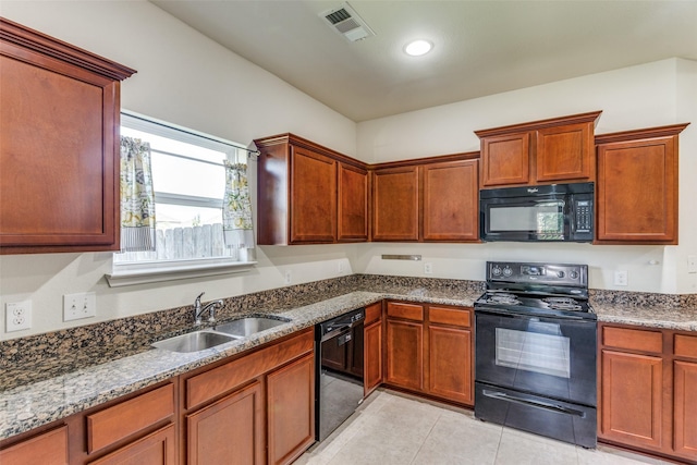 4201 Tower Ln, Crowley, TX 76036 - kitchen with black appliances, a sink, stone countertops, and light tile patterned floors