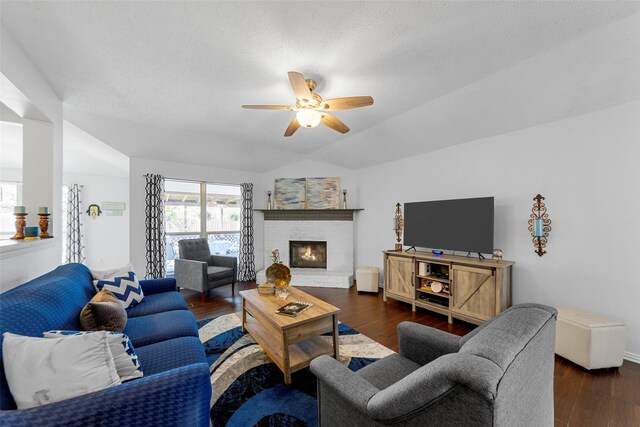 2312 Collier Dr, Mckinney, TX 75071 - living room with a ceiling fan, dark wood-style flooring, a fireplace, and vaulted ceiling